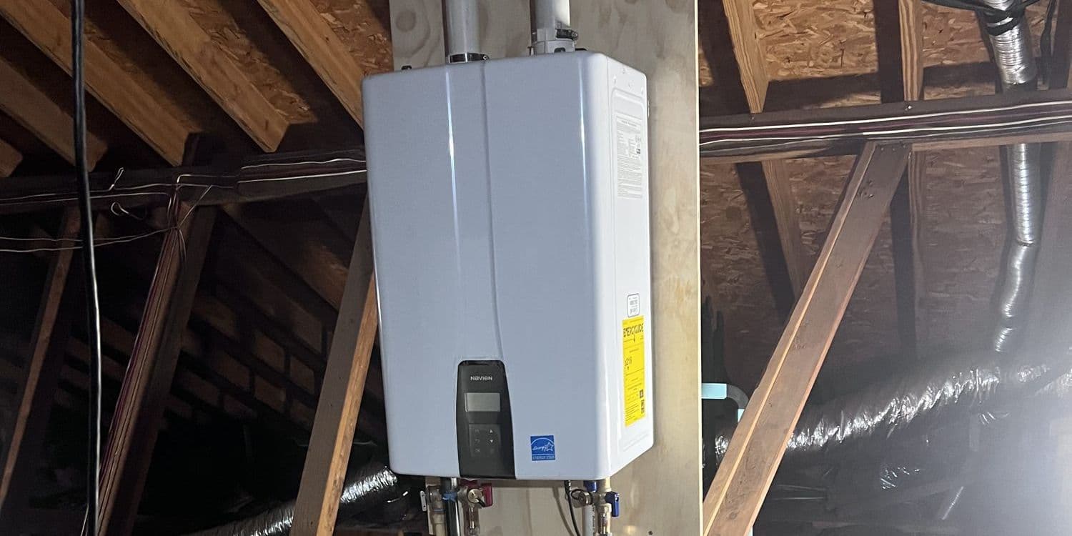 Gas tankless water heater in an attic with a drain pan below