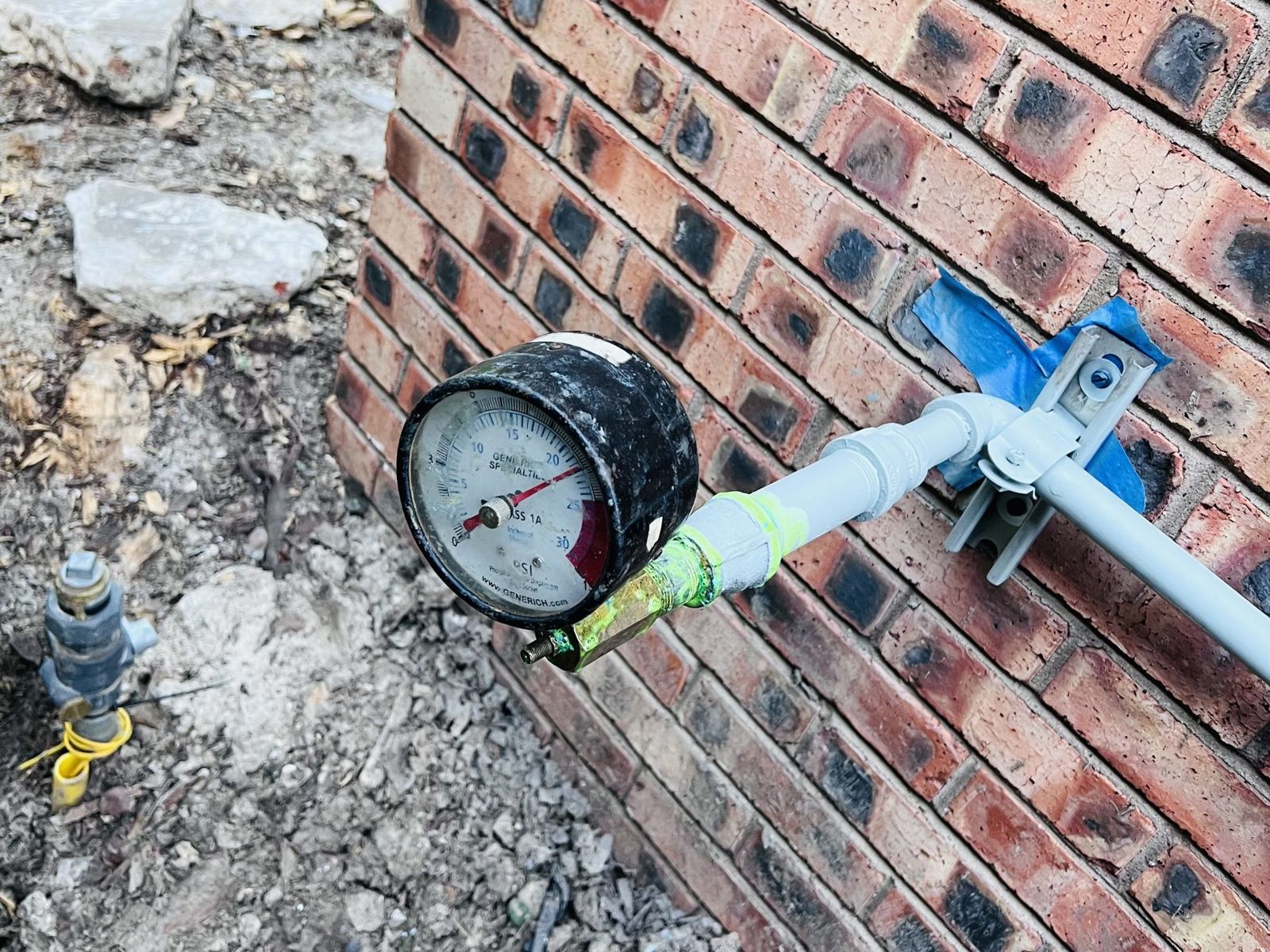 A line under a pressure test. A gauge that will not hold steady is how a leak gets confirmed before anyone cuts concrete.
